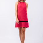 The girl is wearing a pink sleeveless mini dress.