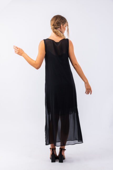 The girl wears a long black sleeveless dress with a cutout.