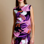 The girl wears a short sleeveless ANTEA floral print silk dress.
