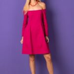 Blonde girl, cyclamen dress, purple background, necklace.