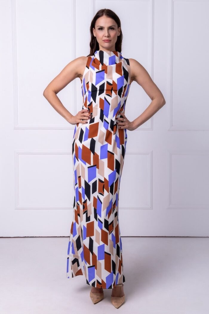 The woman wears a long sleeveless dress made of geometric print silk.