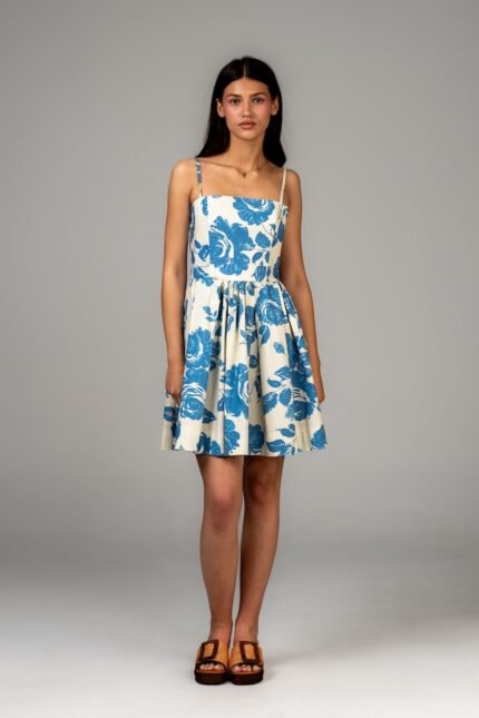 A girl in a blue and white strapless dress with a floral design.