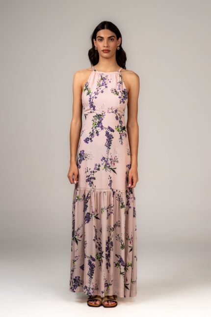 The girl is wearing a long HELENA sleeveless dress with a floral design.