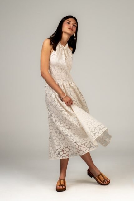 The girl is wearing a NAOMI organdy linen midi dress. It was photographed in motion.