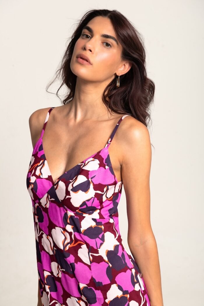 The girl wears a long cyclamen-purple dress with straps.