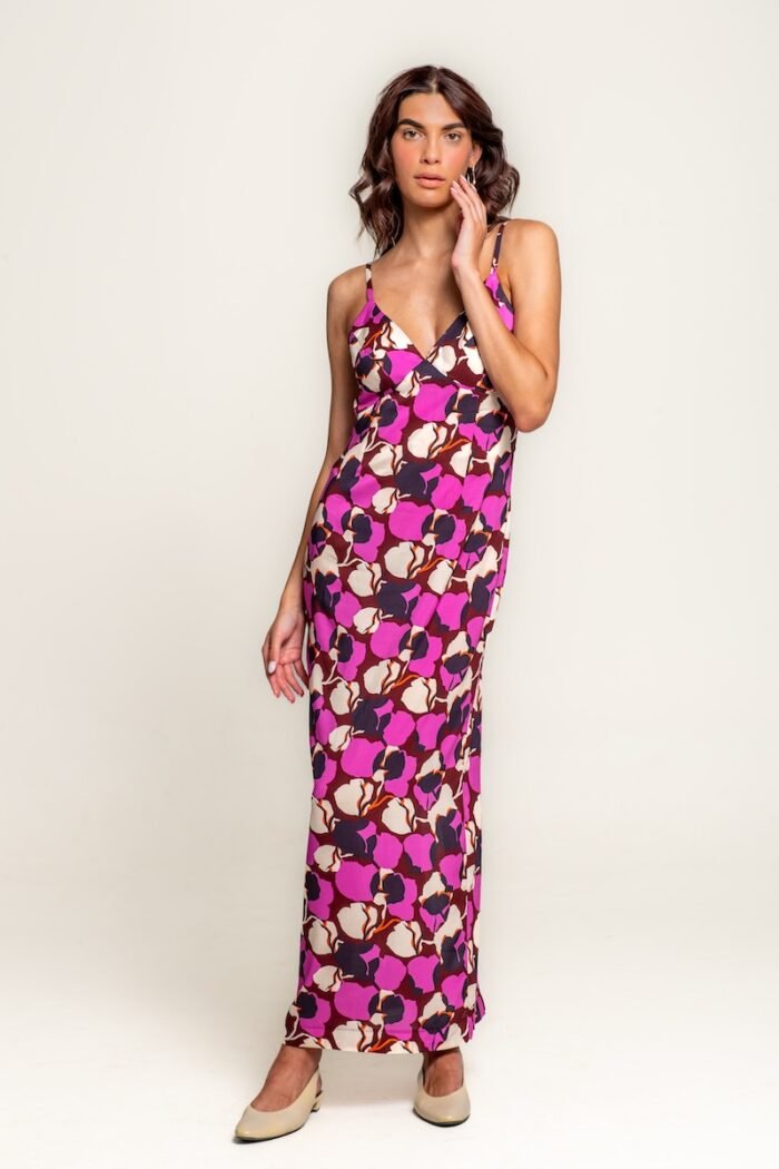 The girl wears a long cyclamen-purple dress with straps.