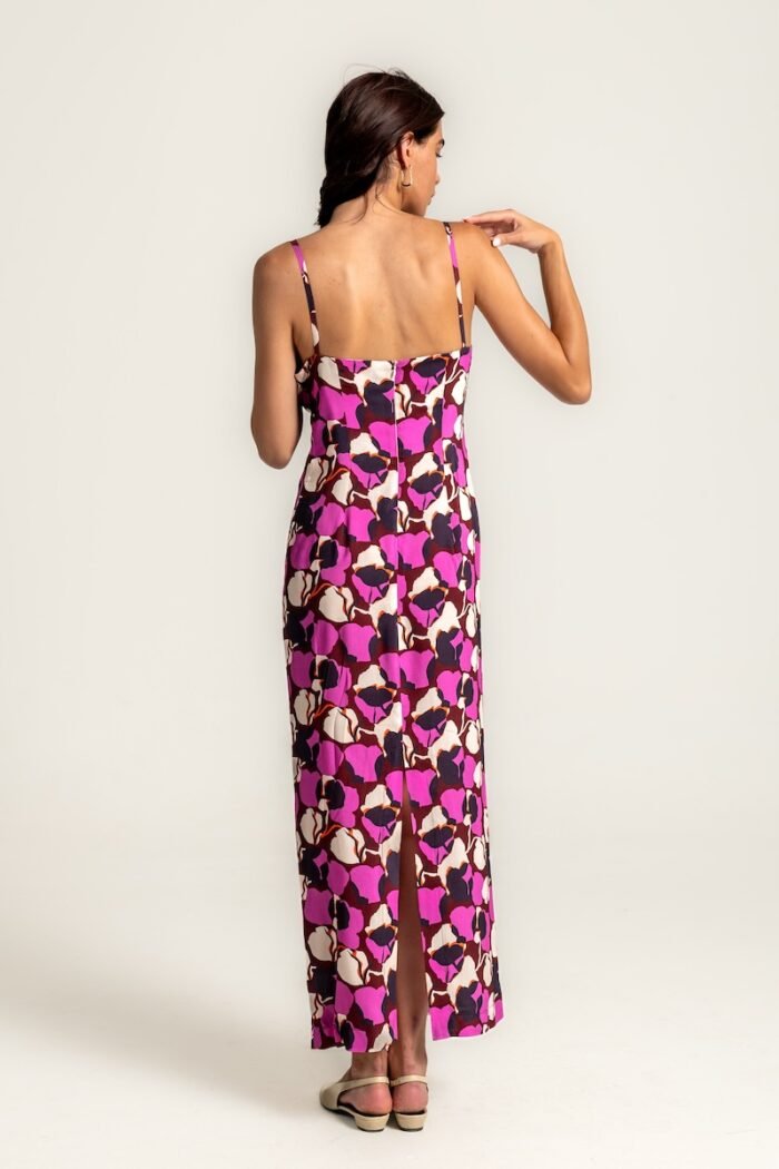 The girl wears a long cyclamen-purple dress with straps.