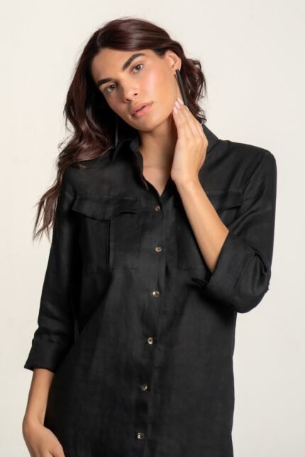 The girl wears a black linen shirt-dress.