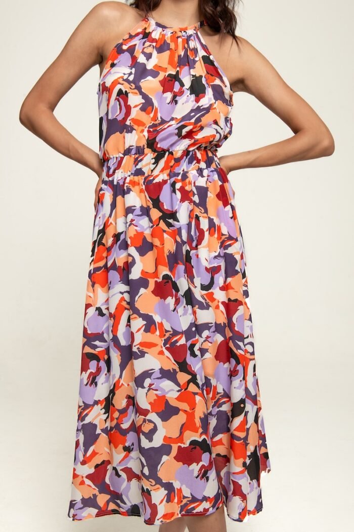 The girl is wearing a colorful patterned sleeveless midi length dress.