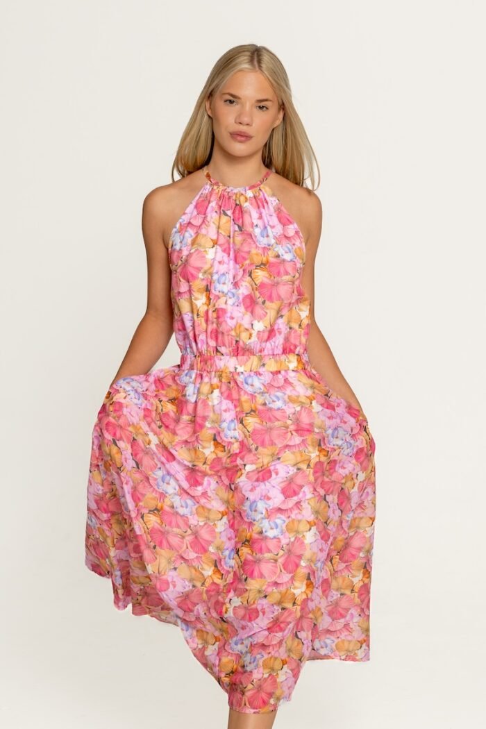 The girl wears a floral sleeveless dress.