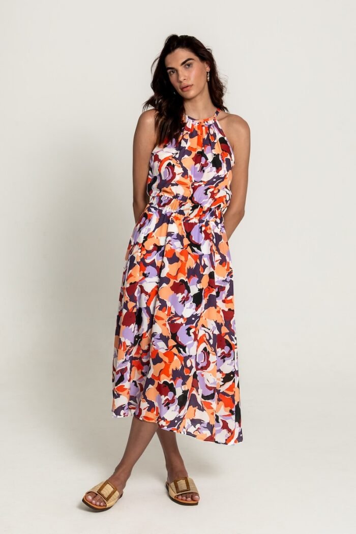 The girl is wearing a colorful patterned sleeveless midi length dress.