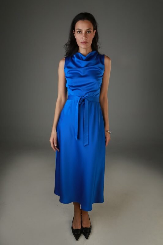 The woman wears a sleeveless midi length blue satin dress.