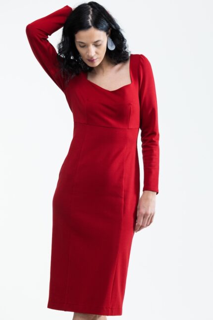 The woman is wearing a midi red dress with long sleeves.