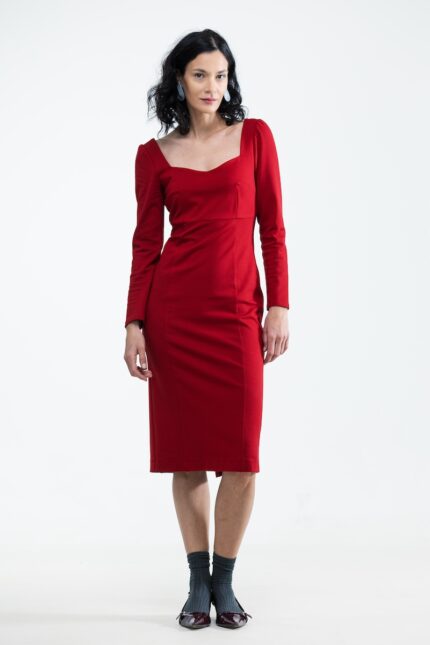 The woman is wearing a midi red dress with long sleeves.