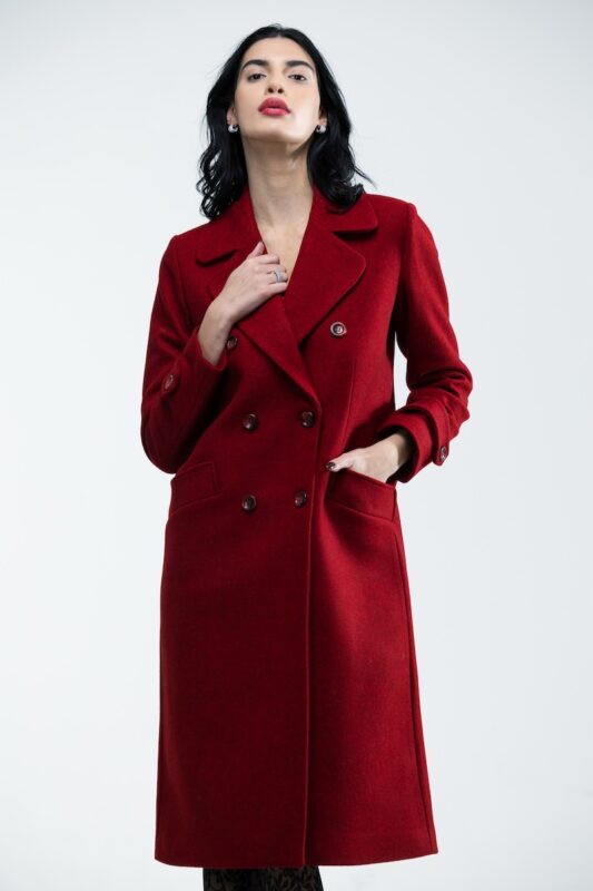 The girl wears a burgundy double-breasted midi coat.