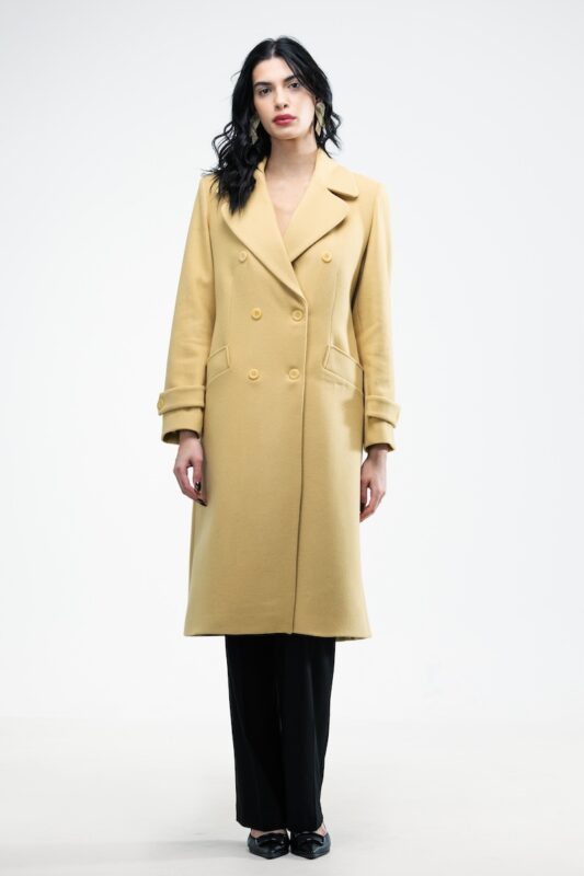 The girl wears a yellow double-breasted midi-length coat.