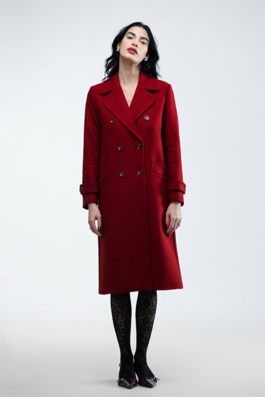 The girl wears a burgundy double-breasted midi coat.