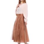 The model is wearing a midi red tulle skirt.
