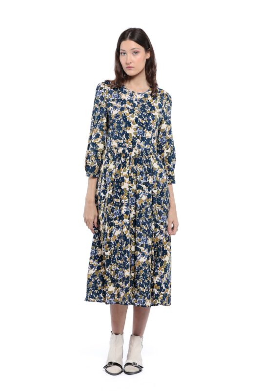 The model is wearing a midi patterned dress with 3/4 sleeves.