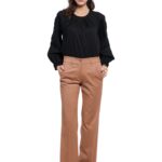 Model nosi uske, ravne REBECCA pantalone u kamel boji.